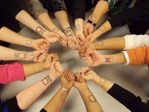 Bach to Rock franchise students show their support for Matt McAndrew by drawing replicas of Matt's "check the box" wrist tattoo.