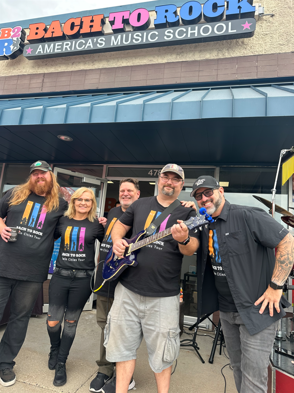 From left: Adam Durand, B2R Coon Rapids;
Judy Shoulak; Don Zbinden, B2R Minnetonka; Jake Shoulak and 
Chris Hawkey, country music star & KFAN celebrity, celebrate the opening of 
Bach to Rock's 25th multi-unit location.
